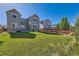 Backyard featuring a well-maintained lawn, and partial view of surrounding homes and wooden fence at 17040 Galapago Ct, Broomfield, CO 80023