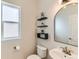 Powder room featuring elegant fixtures, floating shelves, and a modern design at 17040 Galapago Ct, Broomfield, CO 80023