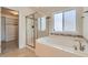 Bright primary bathroom with a soaking tub and walk-in shower at 17040 Galapago Ct, Broomfield, CO 80023