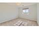 Light-filled bedroom with large window, neutral carpet and modern ceiling light at 17040 Galapago Ct, Broomfield, CO 80023