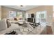 Bright living room features a contemporary design, large windows, and access to an outdoor patio at 17040 Galapago Ct, Broomfield, CO 80023