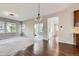 Bright living room seamlessly connecting to the kitchen, with hardwood floors and modern light fixture at 17040 Galapago Ct, Broomfield, CO 80023