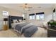 Main bedroom with large upholstered headboard, plush carpeting, and ample natural light at 17040 Galapago Ct, Broomfield, CO 80023
