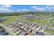 Panoramic aerial view of a neighborhood with a scenic lake, park, and mountain backdrop at 1195 Fox Hills Ct, Erie, CO 80516
