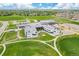 Aerial view of school near suburban neighborhood, highlighting its modern architecture and green surroundings at 1195 Fox Hills Ct, Erie, CO 80516