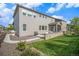 Exterior view of the home featuring a well-manicured lawn and a patio area for outdoor enjoyment at 1195 Fox Hills Ct, Erie, CO 80516