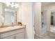 Cozy bathroom featuring a shower-tub combo, vanity, and well-lit mirror at 1195 Fox Hills Ct, Erie, CO 80516