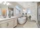 Relaxing bathroom with a soaking tub, double sinks, and a separate shower at 1195 Fox Hills Ct, Erie, CO 80516