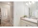 Bright bathroom featuring a vanity with a sink, a mirror, and a separate toilet and bathtub area at 1195 Fox Hills Ct, Erie, CO 80516