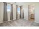 Empty bedroom with multiple windows and easy access to an attached bathroom at 1195 Fox Hills Ct, Erie, CO 80516
