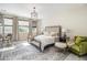 Comfortable main bedroom featuring a decorative chandelier, neutral tones, and plush rug at 1195 Fox Hills Ct, Erie, CO 80516