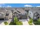 Elevated view of a suburban home featuring a stone facade, manicured lawn, and two-car garage at 1195 Fox Hills Ct, Erie, CO 80516