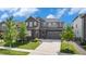 Charming two-story home with a stone and siding facade, featuring a well-manicured lawn at 1195 Fox Hills Ct, Erie, CO 80516