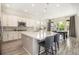 The bright kitchen offers an island with bar seating, stainless appliances and modern finishes at 1195 Fox Hills Ct, Erie, CO 80516