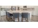 Spacious kitchen island with barstool seating and modern fixtures at 1195 Fox Hills Ct, Erie, CO 80516