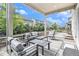 Inviting covered patio with outdoor seating, complemented by well-maintained landscaping and a neighborhood view at 1195 Fox Hills Ct, Erie, CO 80516