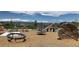 A modern playground with unique play structures, set against a backdrop of mountains and blue sky at 1195 Fox Hills Ct, Erie, CO 80516