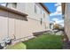 The backyard features stylish modern architectural design, a patch of grass and an outdoor patio at 2339 W 66Th Ave, Denver, CO 80221
