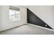 Cozy bedroom featuring a large window and stylish accent wall at 2339 W 66Th Ave, Denver, CO 80221