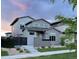 Modern gray home featuring unique architecture, professional landscaping, and a charming walkway to the front door at 2339 W 66Th Ave, Denver, CO 80221