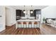 Modern kitchen with sleek black cabinets, a center island, stainless steel appliances, and hardwood flooring at 2339 W 66Th Ave, Denver, CO 80221