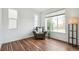 Bright living room with wood floors, a comfortable chair, and a large window, offering a relaxing space at 2339 W 66Th Ave, Denver, CO 80221