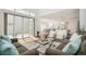 Bright living room featuring hardwood floors, sliding glass doors, and an open layout perfect for entertaining at 2339 W 66Th Ave, Denver, CO 80221