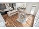 Bright, open-concept kitchen, dining, and living areas with hardwood floors and modern furnishings at 2339 W 66Th Ave, Denver, CO 80221