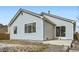 Home exterior and patio view with partial snow in the backyard, complemented by a wood fence for privacy at 4296 Clover Ln, Brighton, CO 80601