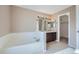 Bathroom with a soaking tub, double sink vanity, and neutral paint at 4296 Clover Ln, Brighton, CO 80601