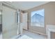 Bright bathroom featuring a glass-enclosed shower at 4296 Clover Ln, Brighton, CO 80601