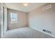 An empty bedroom with neutral-colored walls and carpet and closet with sliding door at 4296 Clover Ln, Brighton, CO 80601