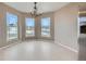 Bright dining area with large windows and modern chandelier at 4296 Clover Ln, Brighton, CO 80601