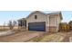 Beautiful house boasts a well-manicured front yard, blue siding, brick accents, and spacious garage at 4296 Clover Ln, Brighton, CO 80601