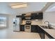 This kitchen features a stainless steel refrigerator, and black cabinets at 4296 Clover Ln, Brighton, CO 80601