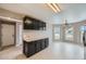 Kitchen and dining area featuring black cabinets, modern decor, and natural light at 4296 Clover Ln, Brighton, CO 80601