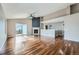 Spacious living room featuring hardwood floors, a fireplace, and access to the backyard through sliding doors at 4296 Clover Ln, Brighton, CO 80601