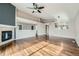 Open-concept living room with hardwood floors, a fireplace, and a seamless transition to other living spaces at 4296 Clover Ln, Brighton, CO 80601