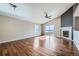 Inviting living room featuring vaulted ceiling, hardwood floors, fireplace, and natural light from windows at 4296 Clover Ln, Brighton, CO 80601