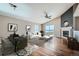 Bright living room featuring vaulted ceiling, fireplace, hardwood floors, and a modern dining table at 4296 Clover Ln, Brighton, CO 80601