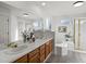 Bright bathroom featuring double sinks, large mirror, soaking tub, and glass shower at 12695 Wolff St, Broomfield, CO 80020