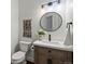 Well-lit powder room featuring decorative wall hanging and wood vanity at 12695 Wolff St, Broomfield, CO 80020