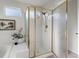 Shower featuring white tiled walls and gold trim at 12695 Wolff St, Broomfield, CO 80020