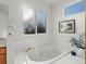 Bright bathroom featuring soaking tub and window at 12695 Wolff St, Broomfield, CO 80020