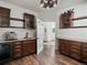 Butler pantry with dark wood cabinets, countertops, and beverage refrigerator at 12695 Wolff St, Broomfield, CO 80020