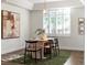 Bright dining room featuring wood floors, large windows with plantation shutters and modern chandelier at 12695 Wolff St, Broomfield, CO 80020