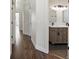 Hallway leading to a bathroom with double vanity and decorative mirrors at 12695 Wolff St, Broomfield, CO 80020