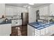 Bright kitchen featuring white cabinetry, blue countertops, and stainless steel appliances at 12695 Wolff St, Broomfield, CO 80020