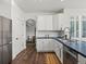 Bright kitchen featuring white cabinets, stainless steel appliances, and an eat-in dining area at 12695 Wolff St, Broomfield, CO 80020