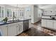 Modern kitchen showcasing white cabinetry, stainless steel appliances, and dark hardwood floors at 12695 Wolff St, Broomfield, CO 80020